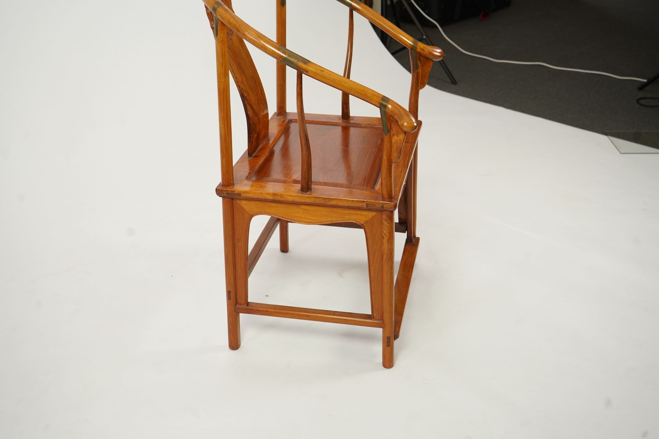 A Chinese huanghuali and brass mounted horseshoe-back armchair, quanyi, late 19th century